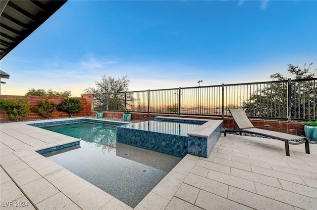 pool at dusk with a fenced in pool, a fenced backyard, and a patio