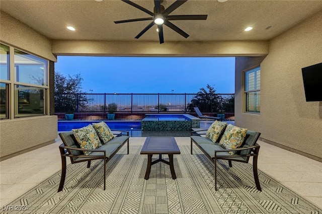 view of patio featuring ceiling fan, an outdoor living space, and fence