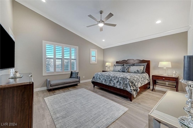 bedroom featuring light hardwood / wood-style floors, vaulted ceiling, ceiling fan, and ornamental molding