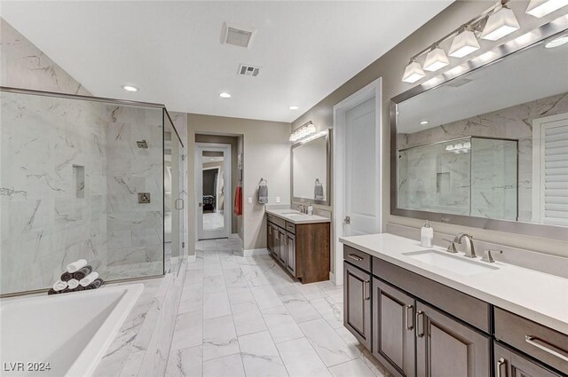 bathroom with vanity and a shower with door