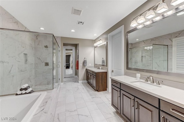 bathroom with marble finish floor, two vanities, a sink, and a marble finish shower