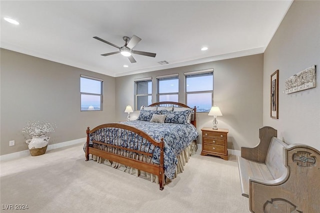 carpeted bedroom featuring ceiling fan, crown molding, and multiple windows