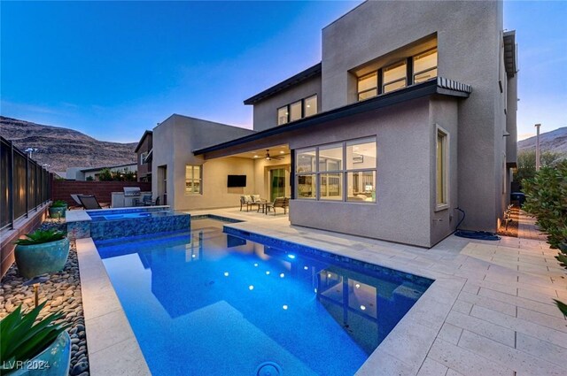 view of swimming pool with a patio area, an in ground hot tub, ceiling fan, and grilling area