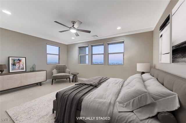 carpeted bedroom with ceiling fan and crown molding