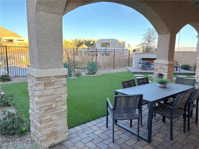 view of patio with an outdoor stone fireplace