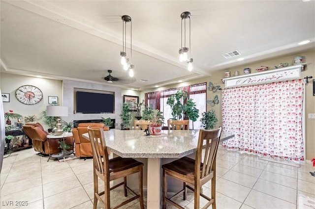 tiled dining area featuring ceiling fan