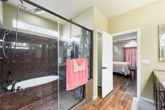 bathroom featuring separate shower and tub, vanity, and hardwood / wood-style flooring