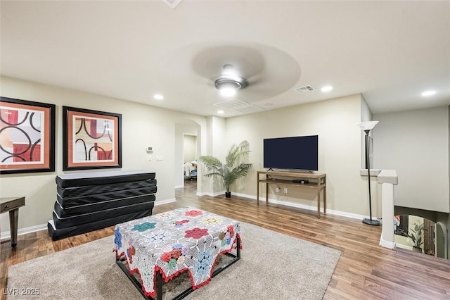 living room with ceiling fan and hardwood / wood-style floors