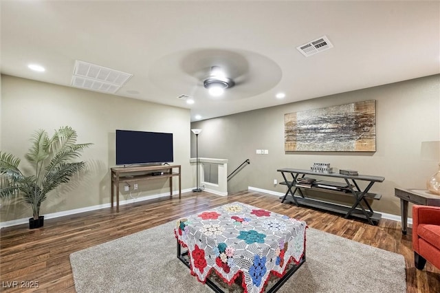 living room featuring dark hardwood / wood-style flooring and ceiling fan