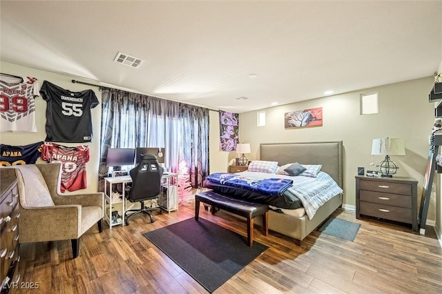 bedroom with wood-type flooring