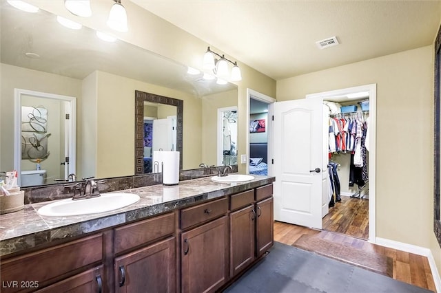 bathroom with vanity, toilet, and wood-type flooring