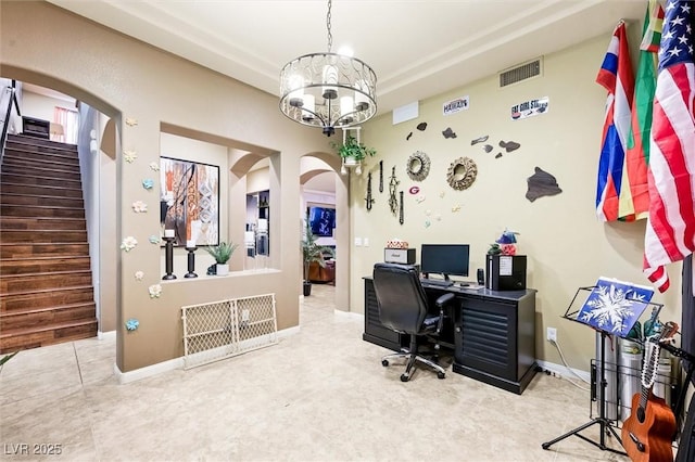 tiled office space with a chandelier