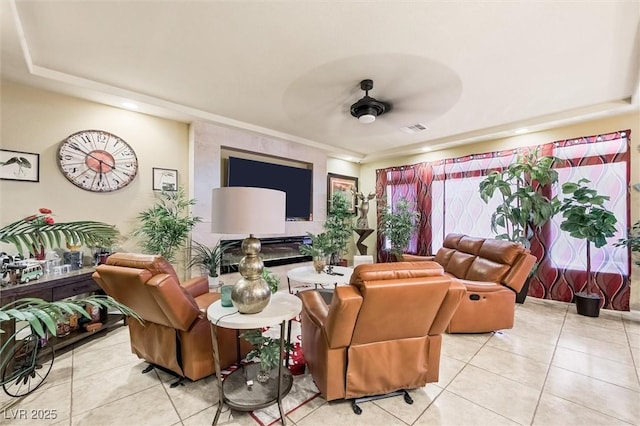 tiled living room featuring ceiling fan