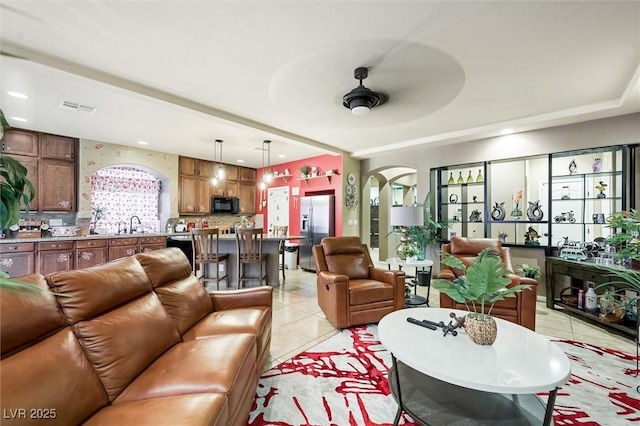 tiled living room featuring ceiling fan