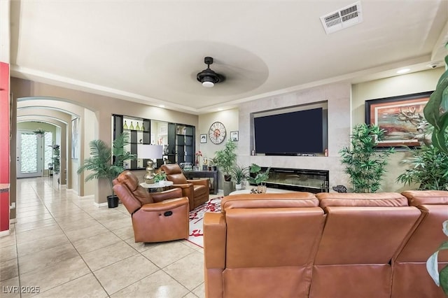 tiled living room with ceiling fan