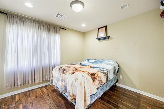 bedroom with dark wood-type flooring