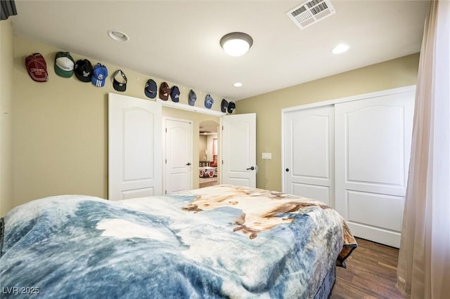 bedroom featuring dark hardwood / wood-style flooring and a closet