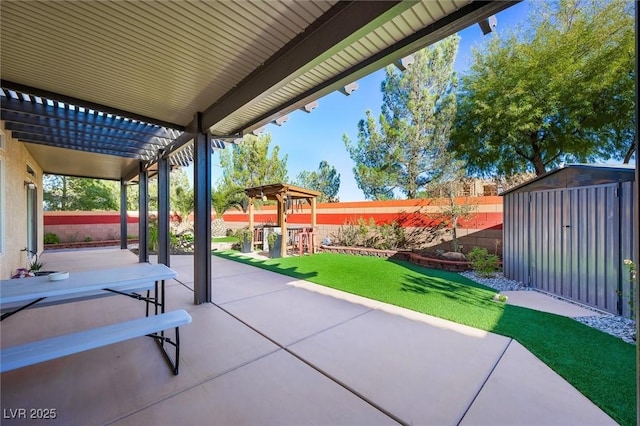 view of patio featuring a storage shed and a pergola