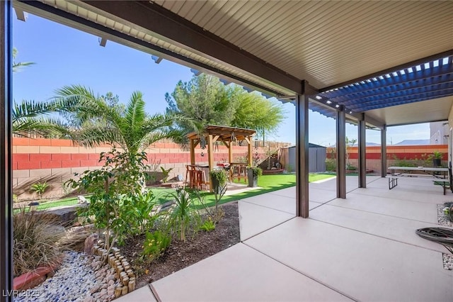 view of patio featuring a pergola and a storage shed