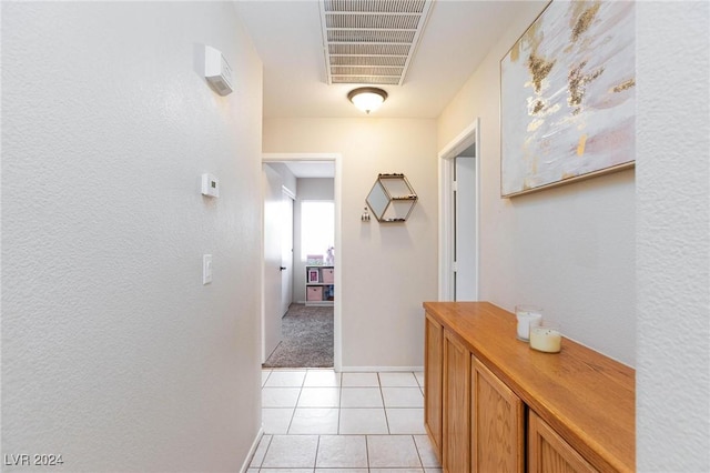 corridor with light tile patterned flooring