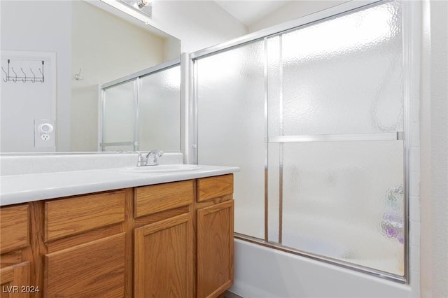 bathroom with vanity and combined bath / shower with glass door