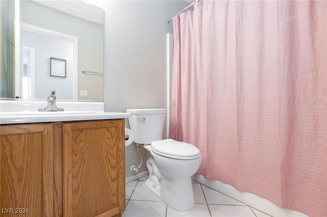 bathroom with tile patterned floors, curtained shower, vanity, and toilet