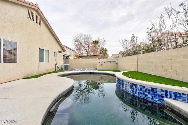 view of pool featuring cooling unit and a patio area