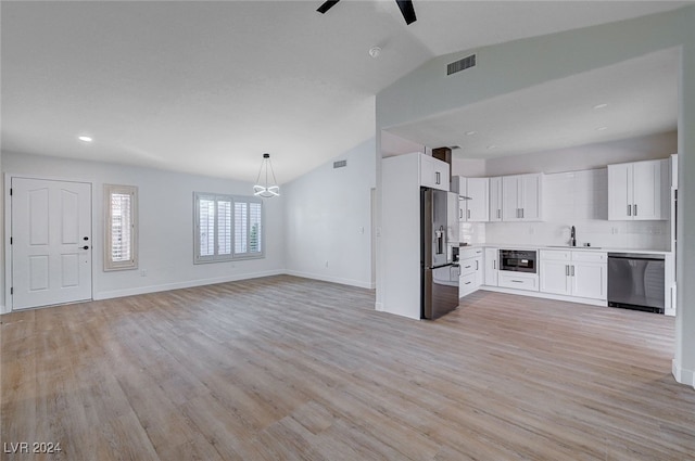 unfurnished living room with ceiling fan, light hardwood / wood-style flooring, sink, and vaulted ceiling