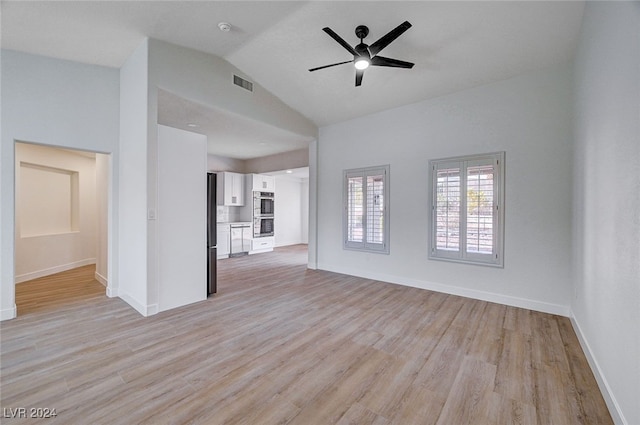 unfurnished living room featuring ceiling fan, light hardwood / wood-style floors, and vaulted ceiling