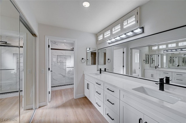 bathroom featuring vanity, toilet, an enclosed shower, and wood-type flooring