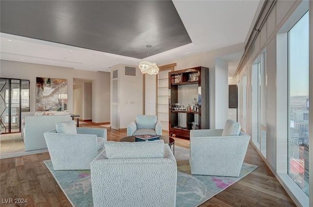 living room featuring light wood-type flooring and a chandelier