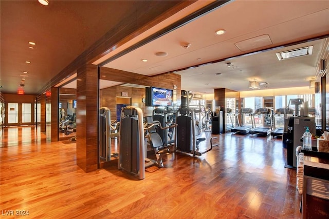 exercise room with light hardwood / wood-style flooring