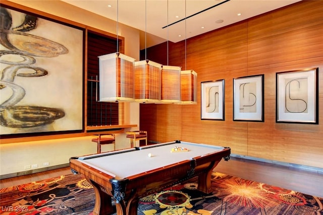 game room with wooden walls, hardwood / wood-style floors, and pool table