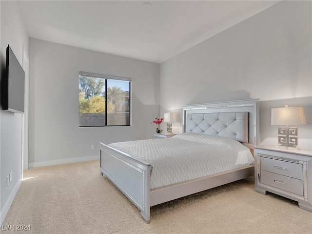 bedroom featuring light carpet