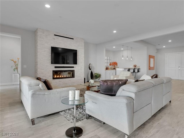 living room with a stone fireplace