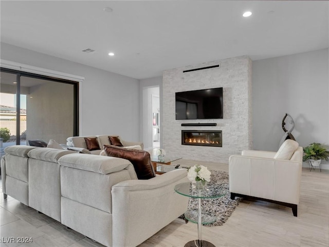 living room with a stone fireplace