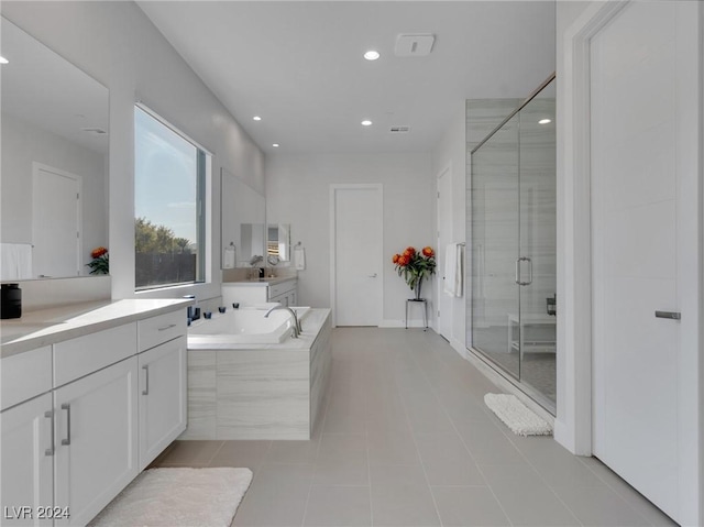 bathroom with tile patterned floors, vanity, and plus walk in shower