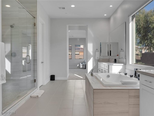 bathroom featuring vanity, a wealth of natural light, tile patterned floors, and shower with separate bathtub