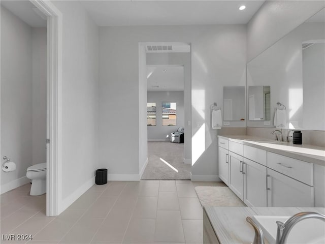 bathroom featuring vanity, tile patterned flooring, and toilet