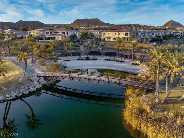 drone / aerial view with a water and mountain view