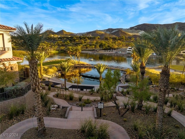 view of community with a water and mountain view