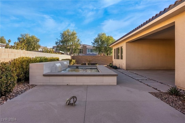 view of patio / terrace with pool water feature