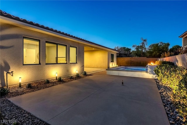 view of side of home with a fenced in pool and a patio area