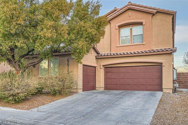 mediterranean / spanish-style house with a garage