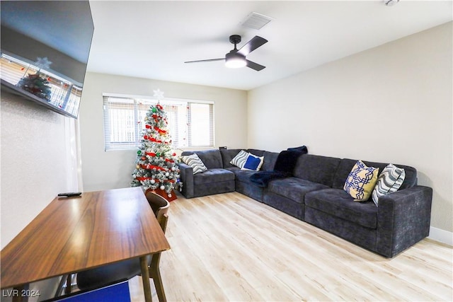 living room with wood-type flooring and ceiling fan