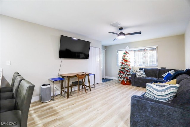 living room with light wood-type flooring and ceiling fan