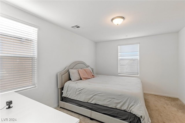 bedroom featuring light carpet