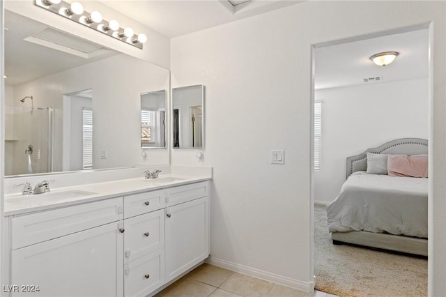 bathroom with tile patterned flooring, vanity, and an enclosed shower