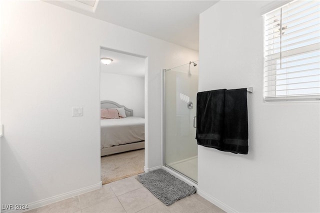 bathroom with tile patterned flooring, an enclosed shower, and a wealth of natural light