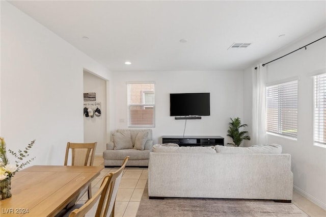 tiled living room featuring a wealth of natural light